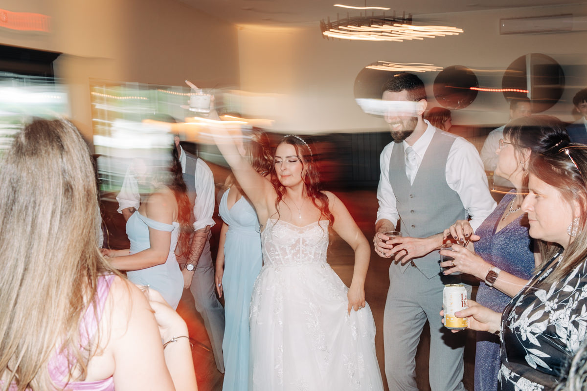 wedding-party-and-bride-and-groom-dance-on-cayuga-lake-in-the-finger-lakes-ny