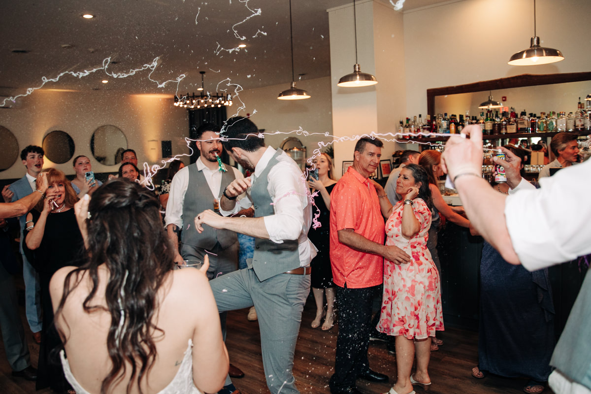 wedding-party-and-bride-and-groom-dance-on-cayuga-lake-in-the-finger-lakes-ny